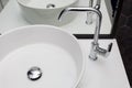 Element of bathroom interior with white sink and large mirror. New wash basin and black hexagonal tiles tile Royalty Free Stock Photo