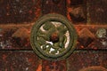 An element of decor of the door of an ancient church in the form of a metal rosette with a winged lion depicted on it Royalty Free Stock Photo