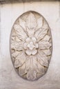 The element of finishing of a facade plaster. Oval inside flower with divergent white leaves