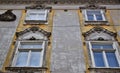 Element, with four windows and a coat of arms, of the facades of a historic building in Graz. Royalty Free Stock Photo
