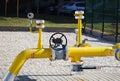 Element gas line high and medium pressure. Yellow transport pipes on the surface of the fence. Regulatory supply system for