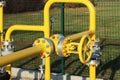 Element gas line high and medium pressure. Yellow transport pipes on the surface of the fence. Regulatory supply system for