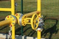 Element gas line high and medium pressure. Yellow transport pipes on the surface of the fence. Regulatory supply system for