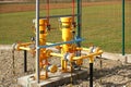 Element gas line high and medium pressure. Yellow transport pipes on the surface of the fence. Regulatory supply system for