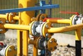 Element gas line high and medium pressure. Yellow transport pipes on the surface of the fence. Regulatory supply system for