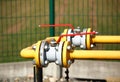 Element gas line high and medium pressure. Yellow transport pipes on the surface of the fence. Regulatory supply system for