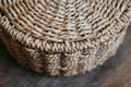 Element of a round wicker basket on a wooden background. Pattern of round texture. Top view. Copy, empty space for text Royalty Free Stock Photo