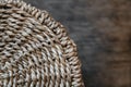 Element of a round wicker basket on a wooden background. Pattern of round texture. Top view. Copy, empty space for text Royalty Free Stock Photo