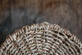 Element of a round wicker basket on a wooden background. Pattern of round texture. Top view. Copy, empty space for text Royalty Free Stock Photo