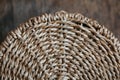 Element of a round wicker basket on a wooden background. Pattern of round texture. Top view. Copy, empty space for text Royalty Free Stock Photo