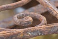 Element of a very rusty wrought iron fence. Abandoned architectural buildings Royalty Free Stock Photo