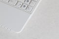 The element of the white compact modern netbook. Photo with a fragment of the computer keyboard with flat white buttons with copy