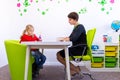 Elementary Age Girl in Child Occupational Therapy Session Doing Playful Exercises With Her Therapist. Royalty Free Stock Photo