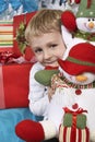 Elementary Boy Holding Stuffed Snowman