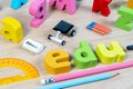 Elementary classroom table with wooden word EDU and education supplies for school background.