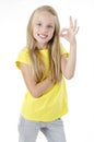 Portrait of cute lovely beautiful adorable sweet with beaming smile in yellow tshirt girl making ok symbol.