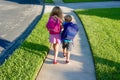 Back to school: Boy and girl walking with backpacks Royalty Free Stock Photo