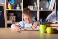 Elementary school. Back to school. Kid is learning in class on background of blackboard. Educational games and toys. Close up