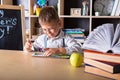 Elementary school. Back to school. Kid is learning in class on background of blackboard. Educational games and toys. Close up