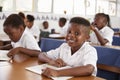 Elementary school boy smiling at camera at his desk in class Royalty Free Stock Photo