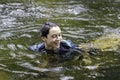 An elementary school boy was having fun playing in the fast flowing stream Royalty Free Stock Photo