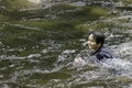 An elementary school boy was having fun playing in the fast flowing stream Royalty Free Stock Photo