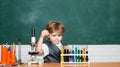 Elementary school. Cheerful smiling little boy having fun against blue wall. Kid from primary school. Blackboard for Royalty Free Stock Photo