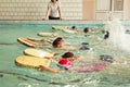 Elementary school children within swimming skills lesson.