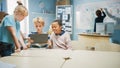 Elementary School Computer Science Class: Two Girls and Boy Use Digital Tablet Computer with Royalty Free Stock Photo