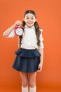 Elementary school day bell schedule. Schooltime concept. Avoid being late. Schoolgirl hold alarm clock. Time to study