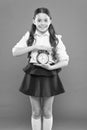 Elementary school day bell schedule. Schooltime concept. Schoolgirl child formal uniform hold alarm clock. Time to study