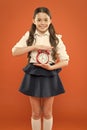Elementary school day bell schedule. Schooltime concept. Schoolgirl child formal uniform hold alarm clock. Time to study