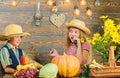 Elementary school fall festival idea. Children play vegetables pumpkin. Kids girl boy wear cowboy farmer style hat