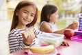 Elementary school girls eating at school lunch table Royalty Free Stock Photo