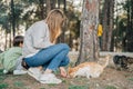 Elementary school kid and his mother petting feeding a stray cat in the city park. Mom and son child boy playing with Royalty Free Stock Photo