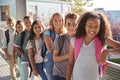 Elementary school kids with backpacks smiling at the camera Royalty Free Stock Photo