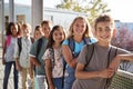 Elementary school kids with backpacks smiling to the camera Royalty Free Stock Photo