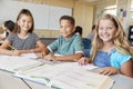 Elementary school kids in class smiling to camera, close up