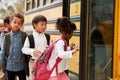 Elementary school kids climbing on to a school bus Royalty Free Stock Photo