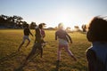 Elementary school kids playing football in a field, back view Royalty Free Stock Photo