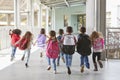 Elementary school kids run from camera in corridor, close up Royalty Free Stock Photo