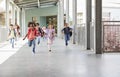 Elementary school kids running to camera in school corridor Royalty Free Stock Photo