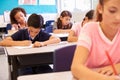 Elementary school kids working at their desks in a classroom Royalty Free Stock Photo