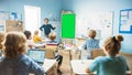 Elementary School Physics Teacher Uses Interactive Digital Whiteboard With Green Screen Mock-up Royalty Free Stock Photo
