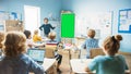 Elementary School Physics Teacher Uses Interactive Digital Whiteboard With Green Screen Mock-up Royalty Free Stock Photo