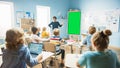 Elementary School Physics Teacher Uses Interactive Digital Whiteboard With Green Screen Mock-up Royalty Free Stock Photo