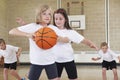Elementary School Pupils Playing Basketball In Gym Royalty Free Stock Photo
