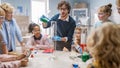 Elementary School Science / Chemistry Classroom: Teacher Shows Chemical Reaction Experiment to Group Royalty Free Stock Photo