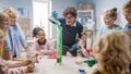 Elementary School Science / Chemistry Classroom: Teacher Shows Chemical Reaction Experiment to Group Royalty Free Stock Photo