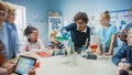 Elementary School Science / Chemistry Classroom: Teacher Shows Chemical Reaction Experiment to Group Royalty Free Stock Photo